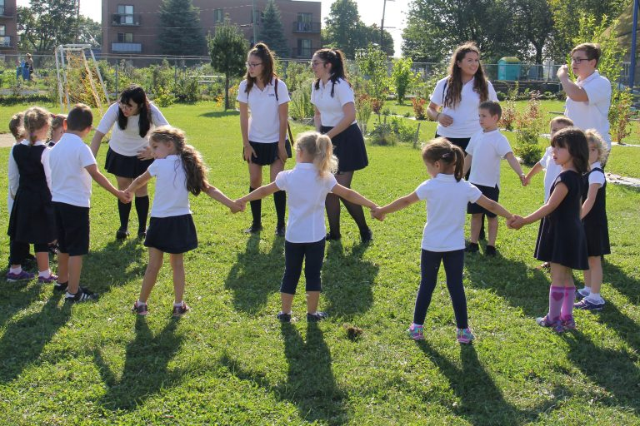 students-holding-hands-outside